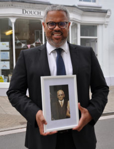 Nick Douch of historic business F C Douch with a photo of his great grandfather Frederick Charles Douch